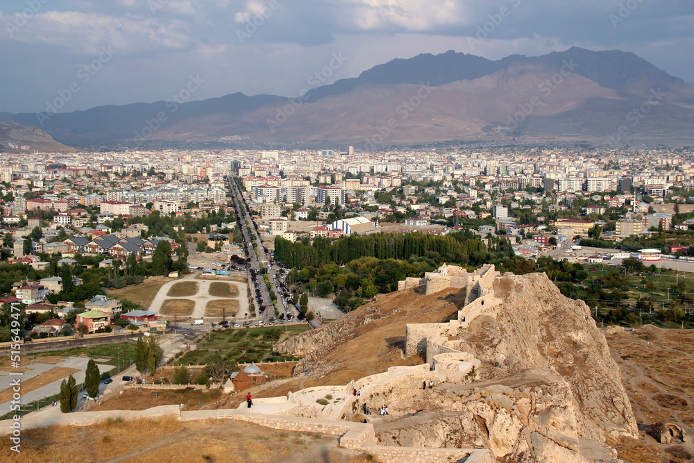 A panoramic view of the city of Van against the background of the mountains with part of the castle of Van on a high cliff in the foreground in the Eastern Anatolia region of Turkey