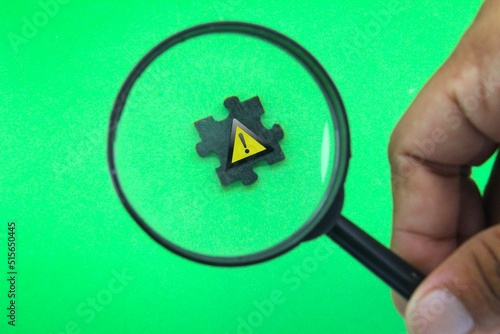 the magnifying glass looks for a sign of caution. the concept of a careful sign photo