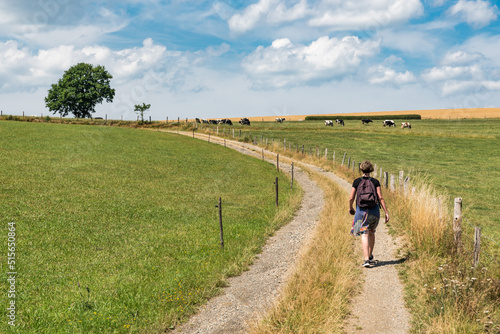 Active woman walking through the fields at the countryside