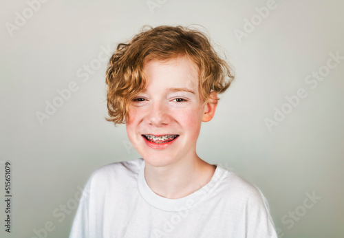 redheaded teen with white shirt on studio © Louis-Photo