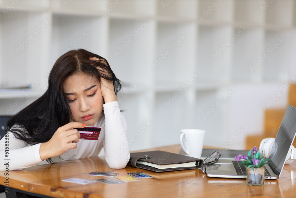 Asian woman worried about overspending and stressed to credit card debt. Concept of financial problems. Asian woman worried about overspending and stressed to credit card debt. Concept of financial problems.