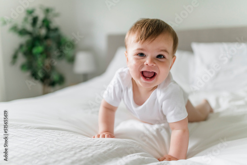 Wallpaper Mural Adorable baby boy in white sunny bedroom in the morning at home Torontodigital.ca