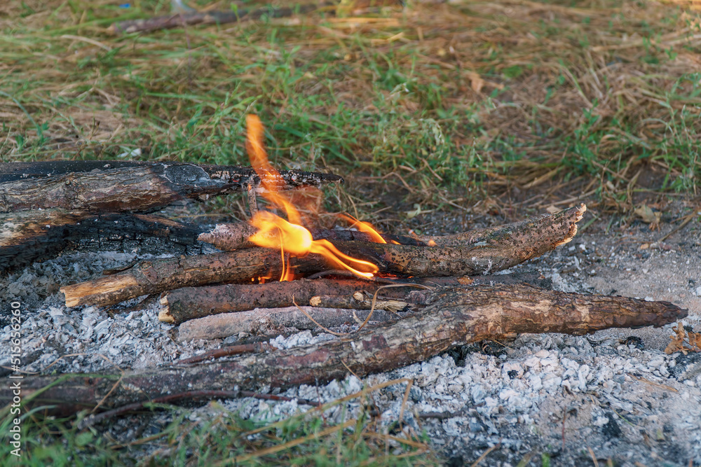 Fototapeta premium View of a small campfire in the camp