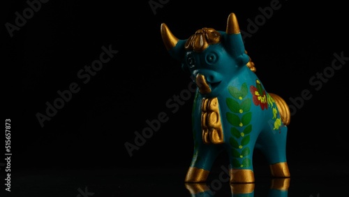 Closeup of a blue bull of Pukara isolated on a black background with copyspace photo