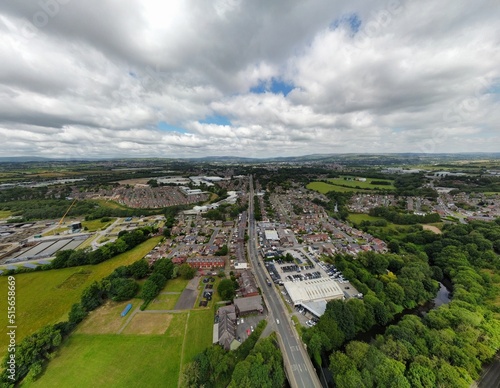 Aerial view looking down onto a busy road with traffic surrounded by buildings. Taken in Bury Lancashire England. 