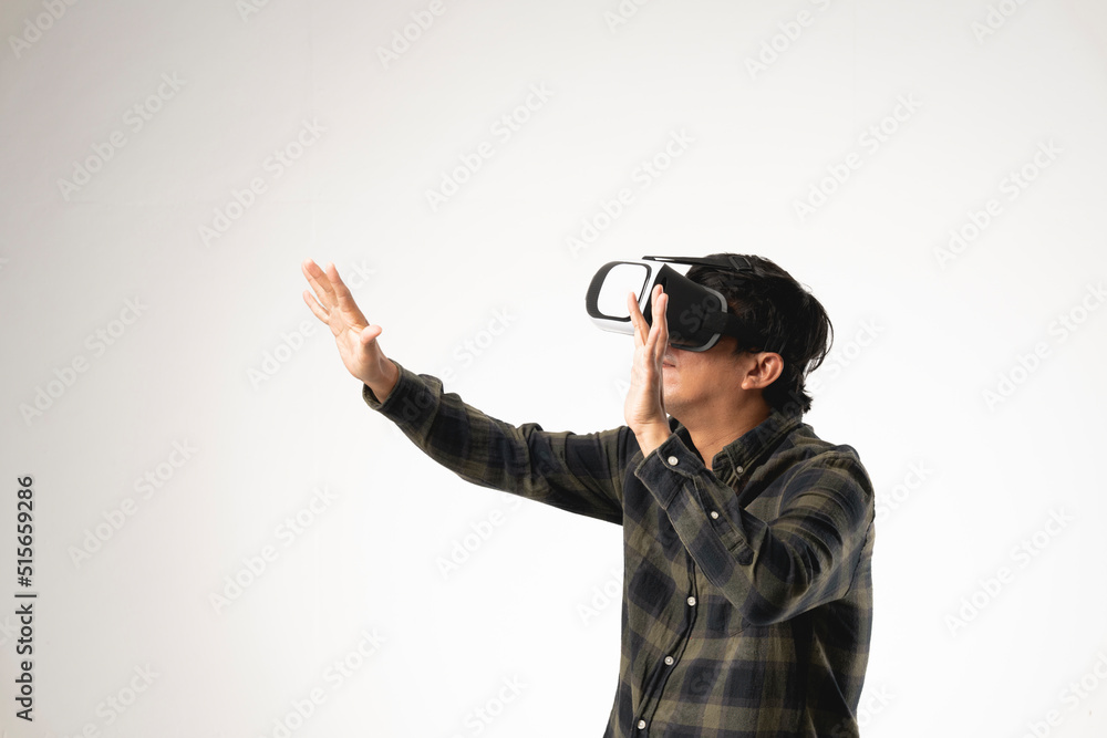 Asian handsome man with using virtual reality headset or VR glass isolate on gray background Asian handsome man with using virtual reality headset or VR glass isolate on gray background