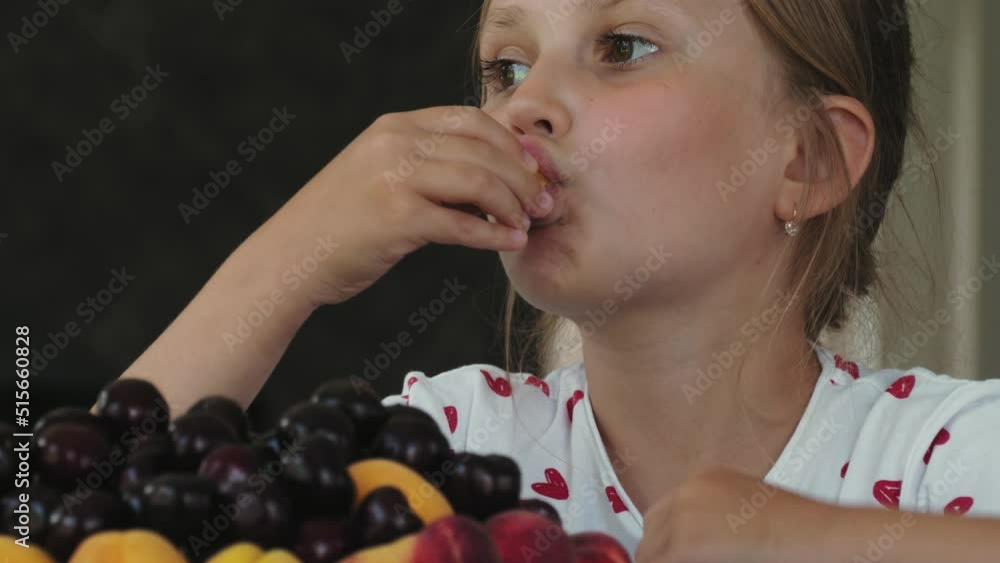 Little girl eats an apricot Little girl eats an apricot