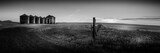 Grayscale panoramic view of a rural area with a range of granaries, Montana, USA