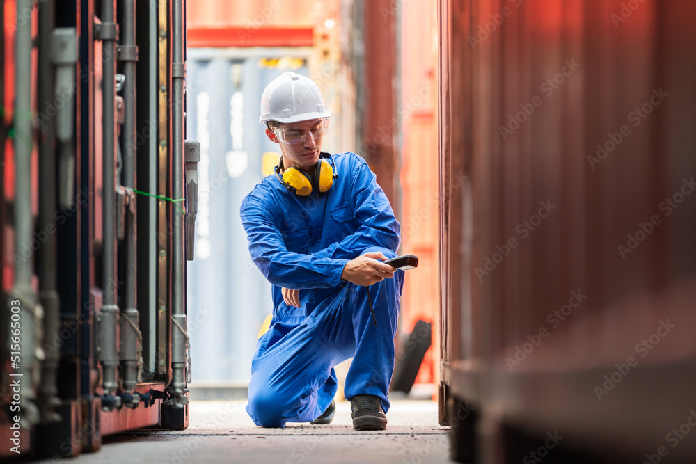 Dock worker man in safety vest holding barcode scanner and inspector the quality of container at shipping yard. Import and export product. Manufacturing transportation and global business concept Dock worker man in safety vest holding barcode scanner and inspector the quality of container at shipping yard. Import and export product. Manufacturing transportation and global business concept