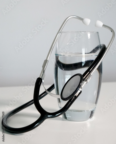 close up stethoscope and glass of water  