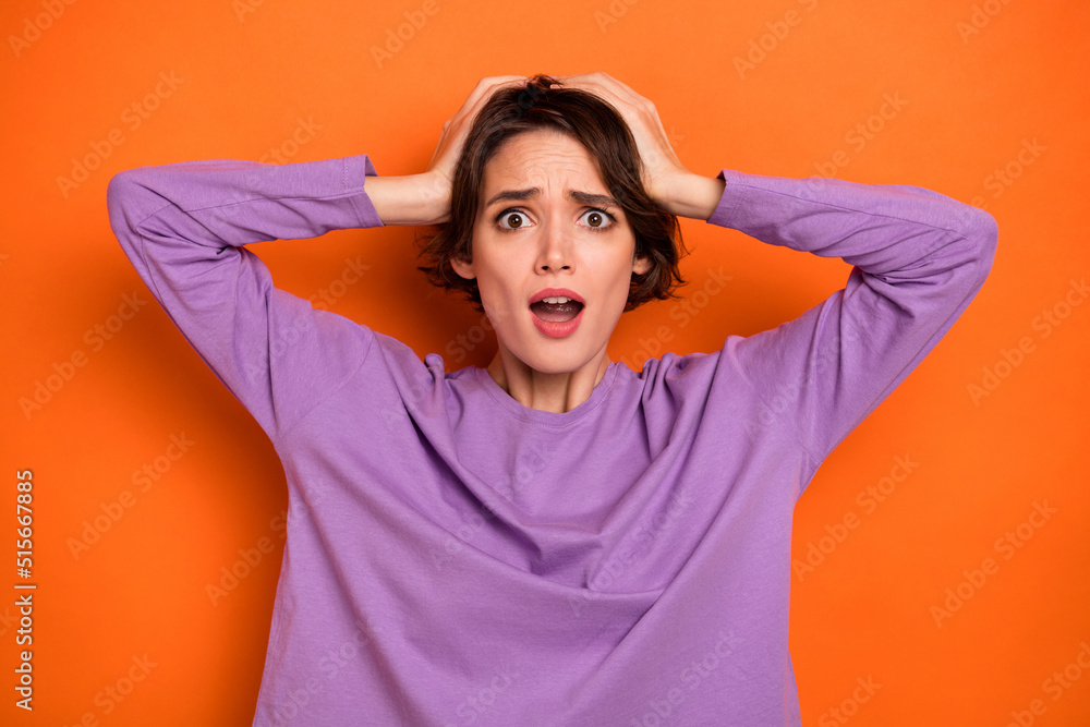 Photo of amazed impressed lady wear violet sweatshirt arms head open mouth isolated orange color background Photo of amazed impressed lady wear violet sweatshirt arms head open mouth isolated orange color background
