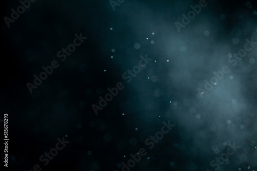 Glowing blue highlights. Wallpaper pattern. Blue sparkling spots. Dust or fog on a black background.