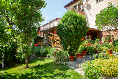 Beatiful backyard garden with flowers in full bloom in sunny day in summer.
