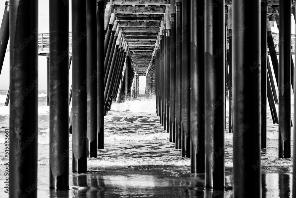 Under an ocean pier during low tide - black and white Under an ocean pier during low tide - black and white