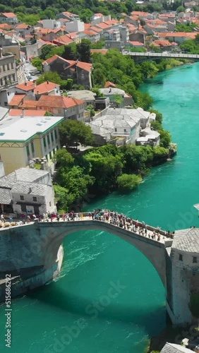 Vertical aerial footage of the crowded Mostar Bridge (Stari Most) in Mostar, Bosnia and Herzegovina photo