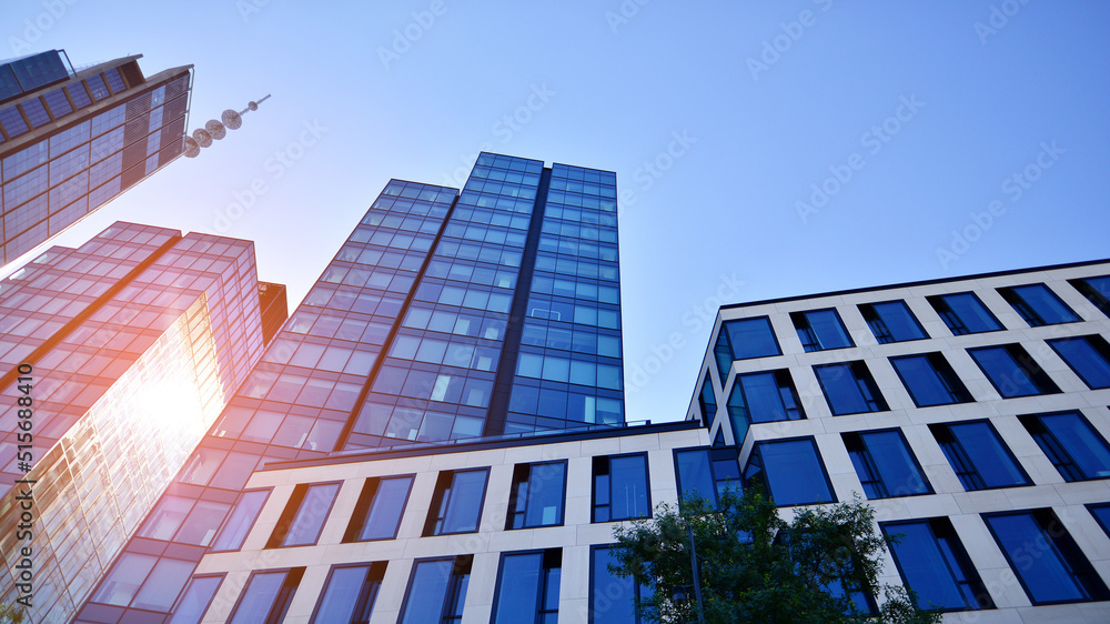custom made wallpaper toronto digitalBottom view of modern skyscraper in business district against blue sky. Looking up at business buildings in downtown. Rising sun on the horizon.