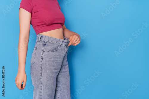 The girl in the blue jeans is a few sizes too big. photo
