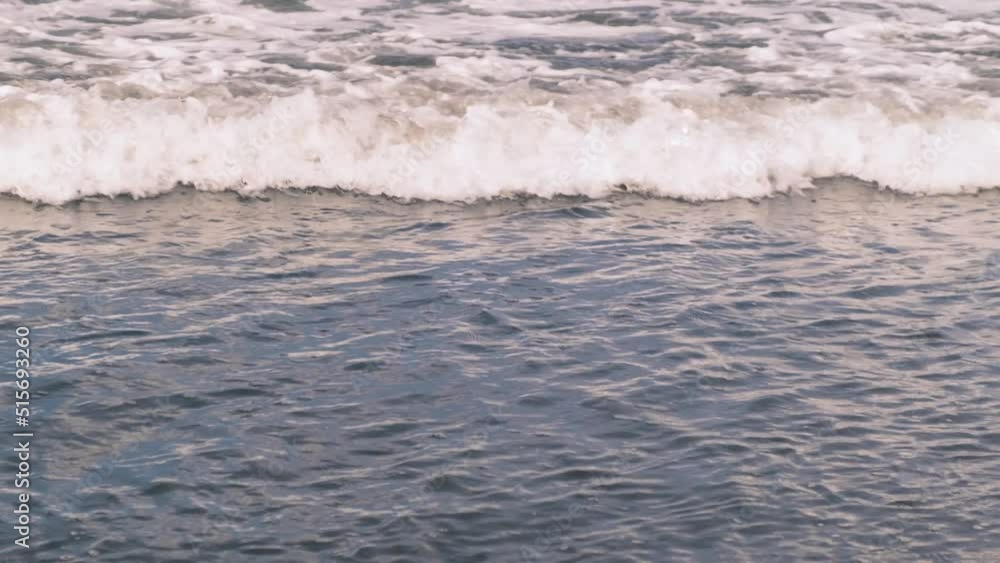 Slow motion of bubbling foaming ocean waves off the coast of the island of Bali in Indonesia on a sunny day. The power of nature, the water element, the Indian Ocean. 4k Slow motion of bubbling foaming ocean waves off the coast of the island of Bali in Indonesia on a sunny day. The power of nature, the water element, the Indian Ocean. 4k