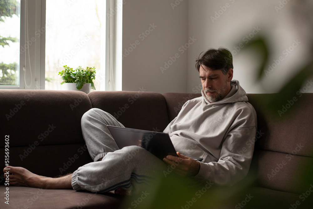 man sitting on sofa
