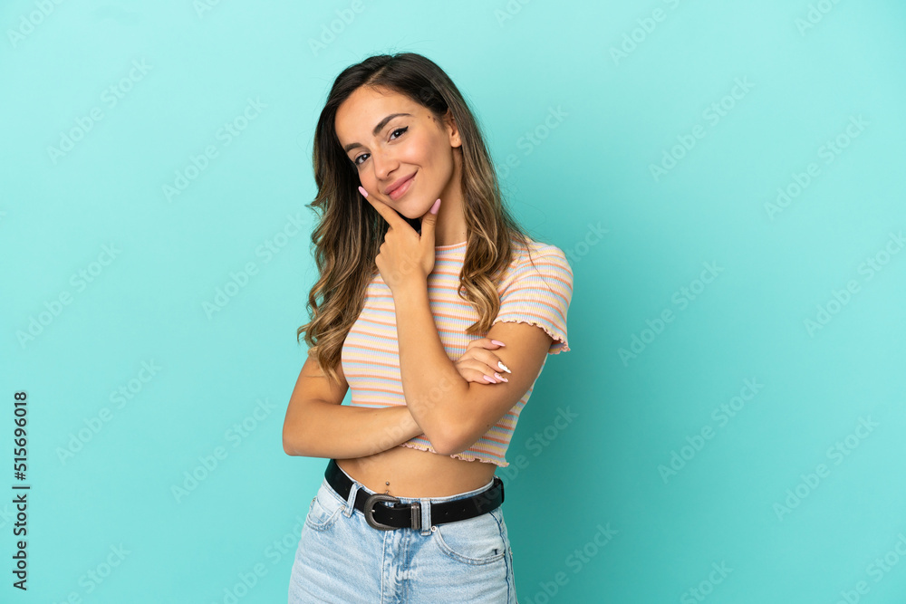 Young woman over isolated blue background happy and smiling Young woman over isolated blue background happy and smiling