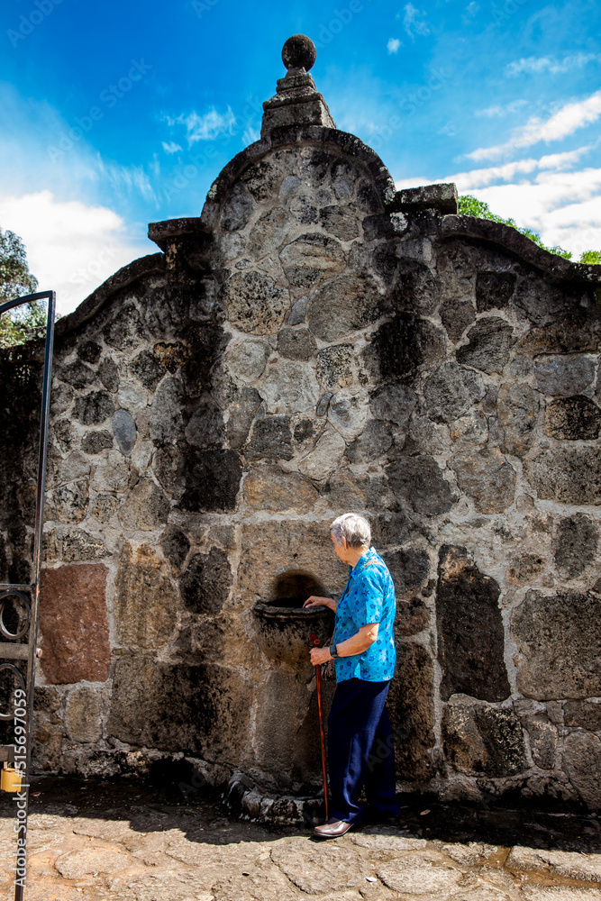 Senior woman at the beautiful historical church La Ermita built in the sixteenth century in the town of Mariquita in Colombia Senior woman at the beautiful historical church La Ermita built in the sixteenth century in the town of Mariquita in Colombia