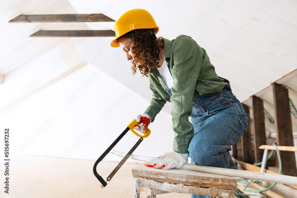 Young woman, professional builder makes room repairs using different work tools. Gender equality. Work, occupation, apartment renovation. Young woman, professional builder makes room repairs using different work tools. Gender equality. Work, occupation, apartment renovation.