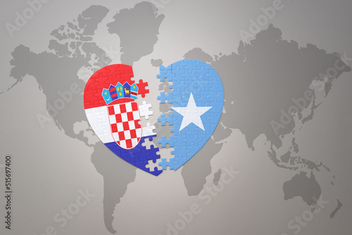 puzzle heart with the national flag of croatia and somalia on a world map background.Concept.
