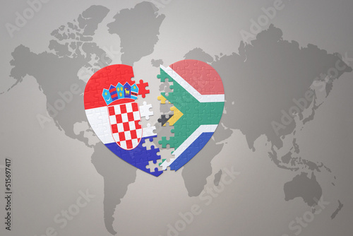 puzzle heart with the national flag of croatia and south africa on a world map background.Concept.