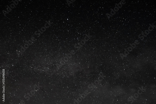 Stars in Dark Night Sky with Faint Clouds