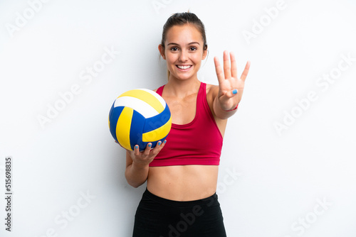 Young caucasian woman playing volleyball isolated on white background happy and counting four with fingers