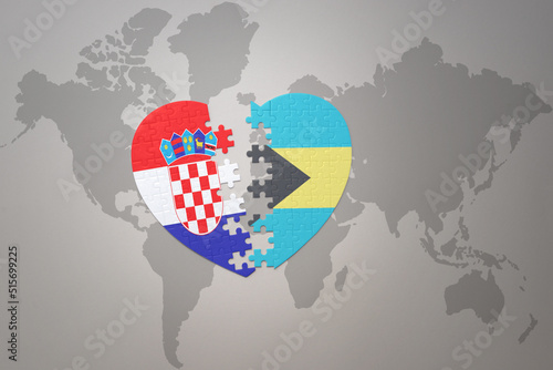 puzzle heart with the national flag of croatia and bahamas on a world map background.Concept.