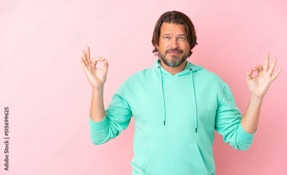 Senior dutch man isolated on pink background in zen pose Senior dutch man isolated on pink background in zen pose