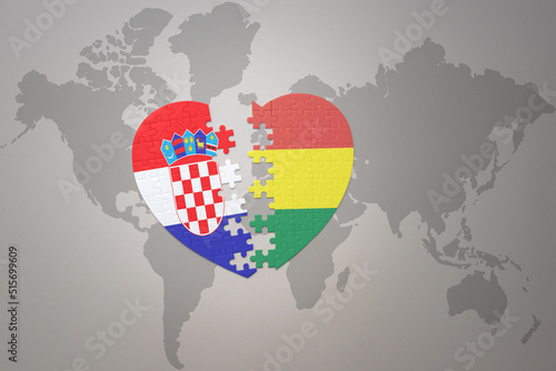 puzzle heart with the national flag of croatia and bolivia on a world map background.Concept.