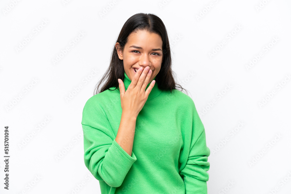 Young Colombian woman isolated on white background happy and smiling covering mouth with hand Young Colombian woman isolated on white background happy and smiling covering mouth with hand