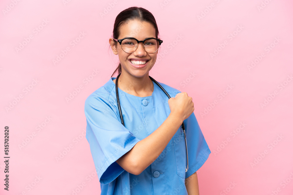 Young nurse Colombian woman isolated on pink background celebrating a victory Young nurse Colombian woman isolated on pink background celebrating a victory