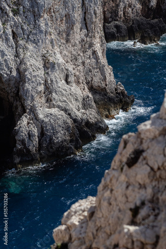 waves crashing on beautiful rocks in the sea during sunny day