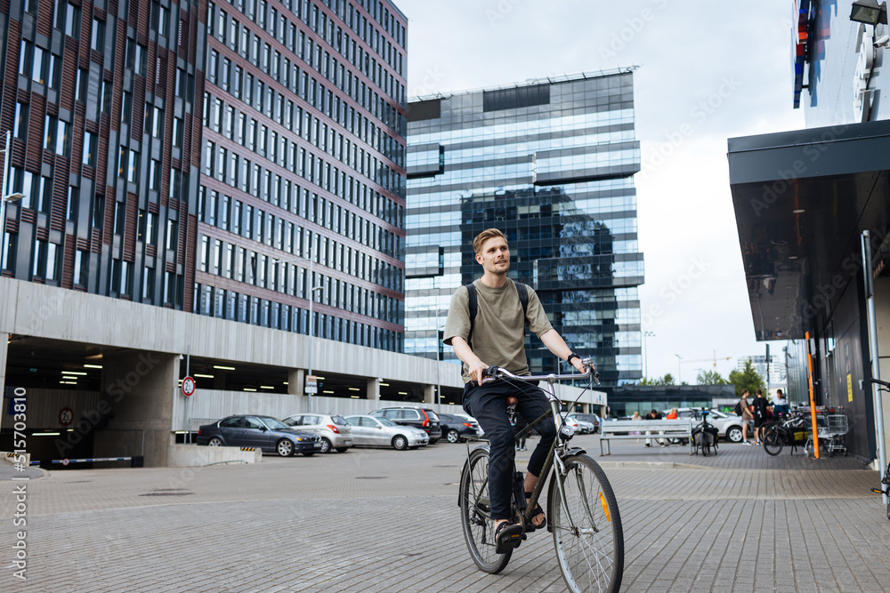 Fotka „Young man riding a bike. Sustainable micro mobility transport