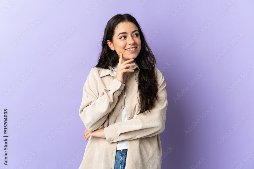 Young caucasian woman isolated on purple background thinking an idea while looking up Young caucasian woman isolated on purple background thinking an idea while looking up