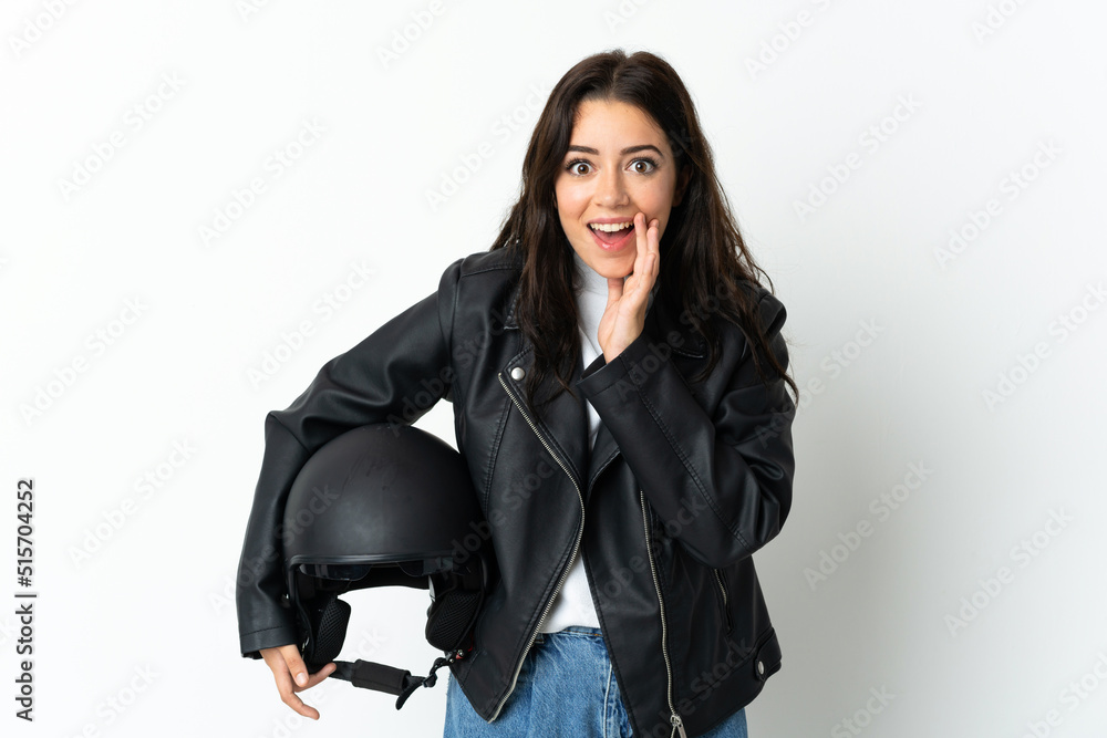 Woman holding a motorcycle helmet isolated on white background with surprise and shocked facial expression Woman holding a motorcycle helmet isolated on white background with surprise and shocked facial expression