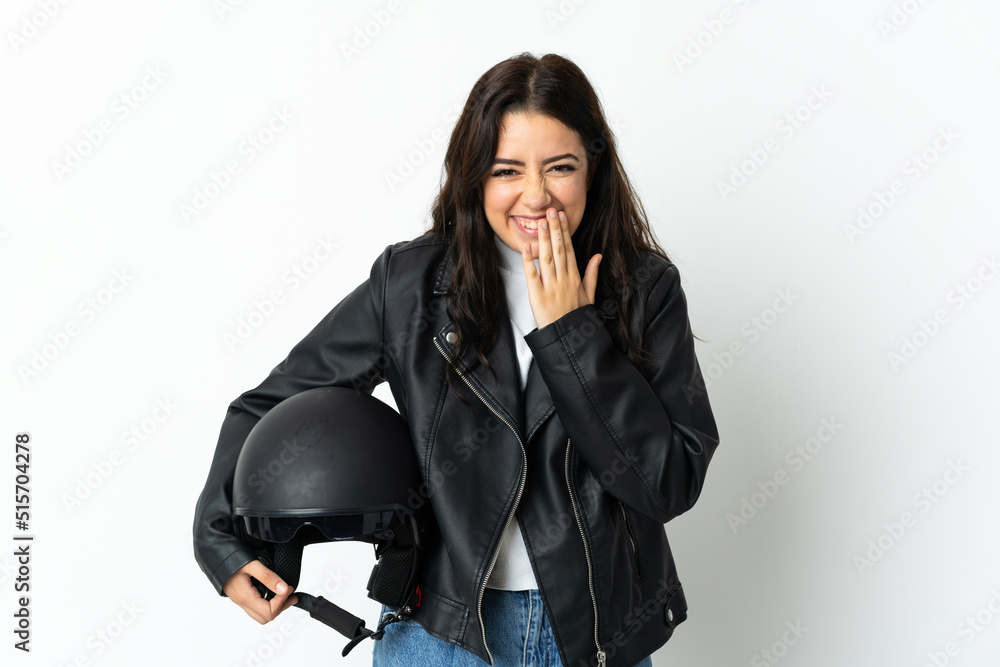 Woman holding a motorcycle helmet isolated on white background happy and smiling covering mouth with hand Woman holding a motorcycle helmet isolated on white background happy and smiling covering mouth with hand