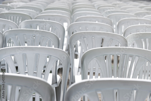 White plastic chairs lined up for a performance