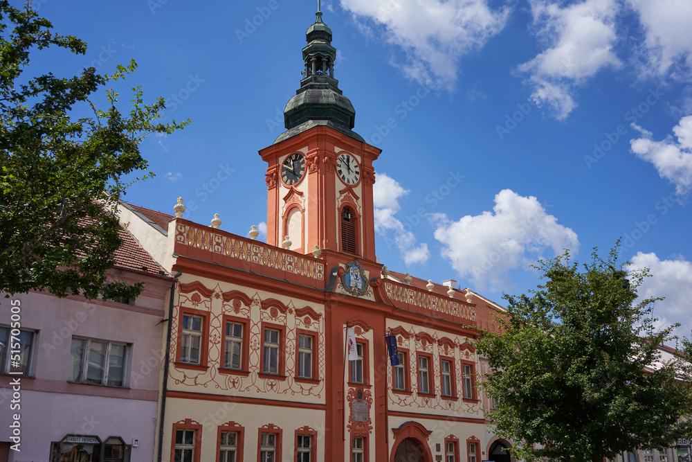 Rakovnik, Czech Republic - July 2, 2022 - the Hus Square with the town hall and historical houses on a sunny summer afternoon Rakovnik, Czech Republic - July 2, 2022 - the Hus Square with the town hall and historical houses on a sunny summer afternoon