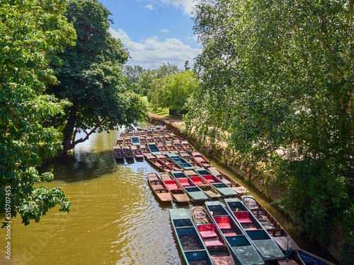 Colorful punting boats in Cherwell river in Oxford, England, UK, Europe. View from Magdalen bridge photo
