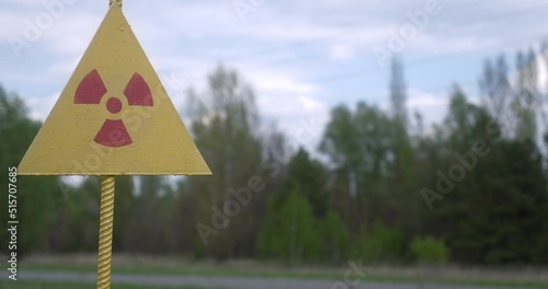 Car passing radioactive contamination sign