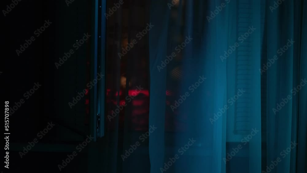 window with the background of the night. night stuffiness, city dwellers put a fan on the window window with the background of the night. night stuffiness, city dwellers put a fan on the window