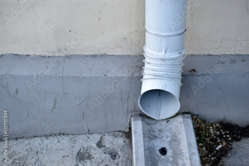 Downpipe near the wall of a house in the city