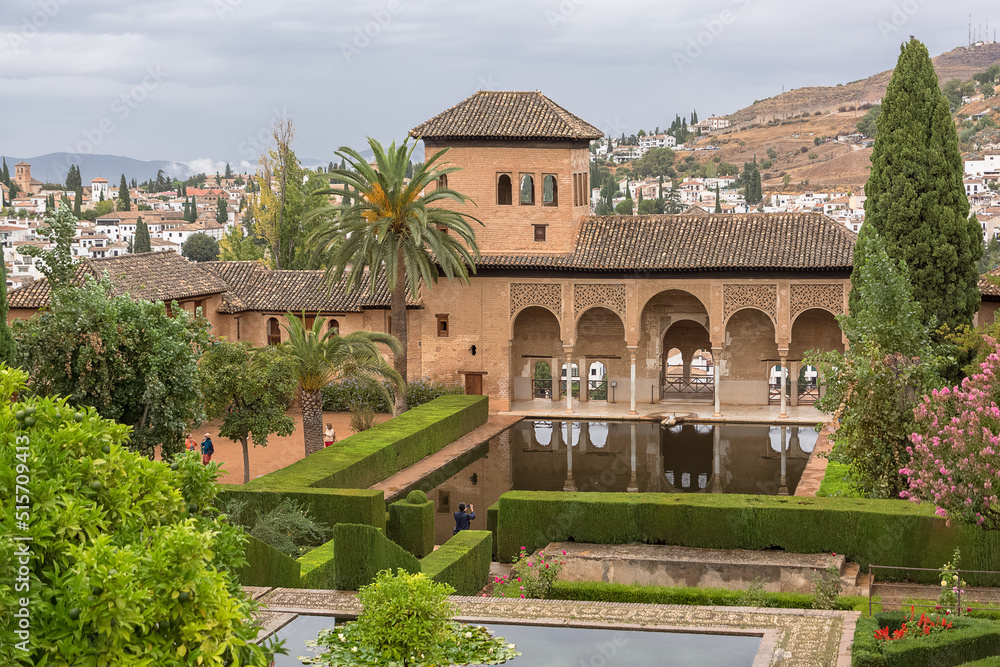 View at the Partal Palace or Palacio del Partal , a palatial structure around gardens and water lake inside the Alhambra fortress complex located in Granada, Spain