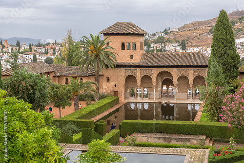View at the Partal Palace or Palacio del Partal , a palatial structure around gardens and water lake inside the Alhambra fortress complex located in Granada, Spain photo
