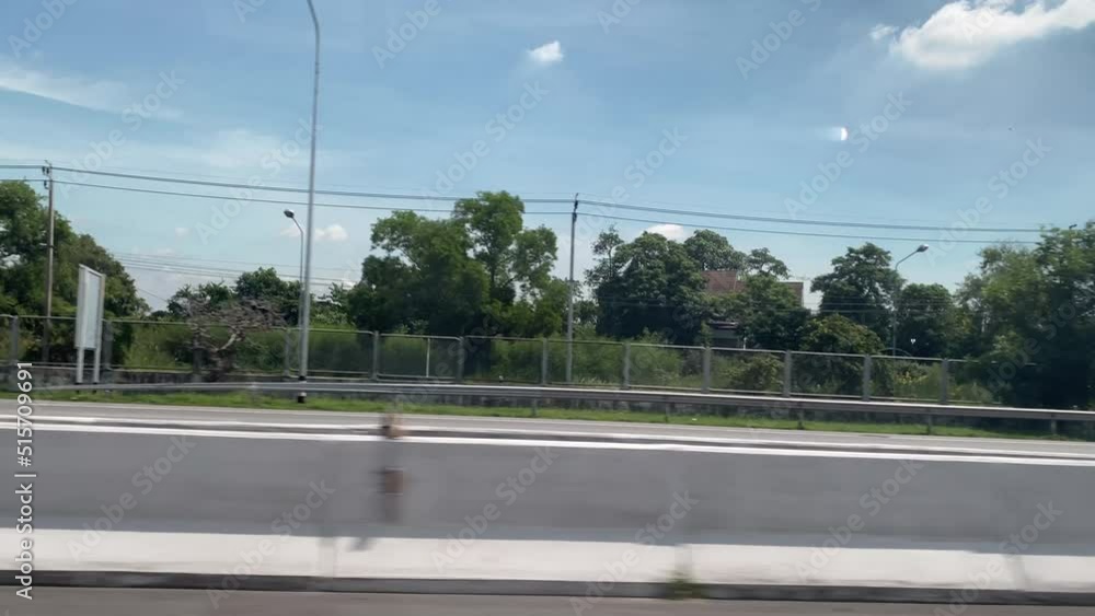 View through the side window of moving car on the road. View through the side window of moving car on the road.