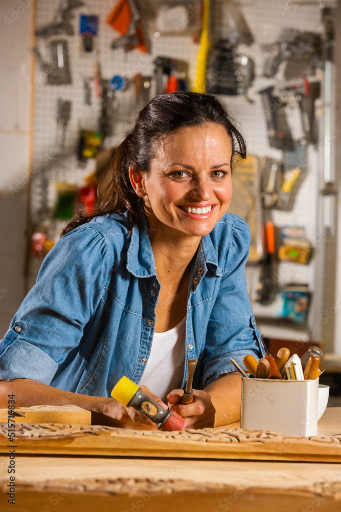 Woman woodworker in her workshop, smiling portrait